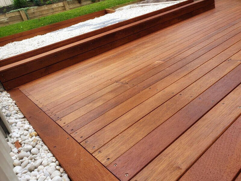 Finished hardwood decking with a pebble border
