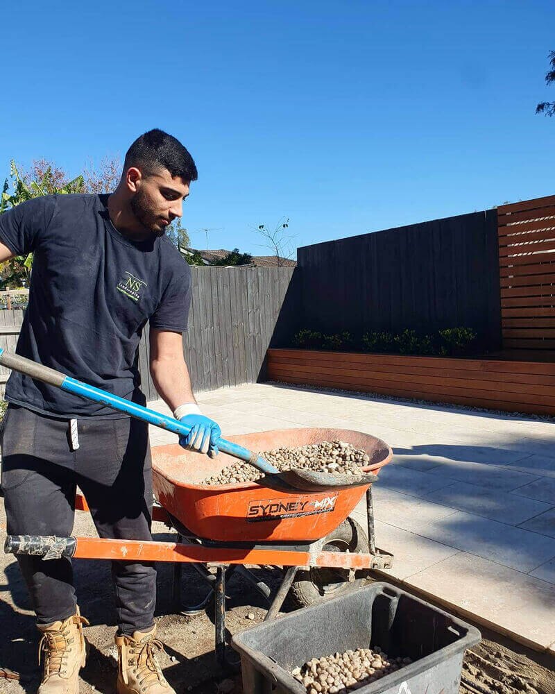 Landscaper preparing material during outdoor construction work