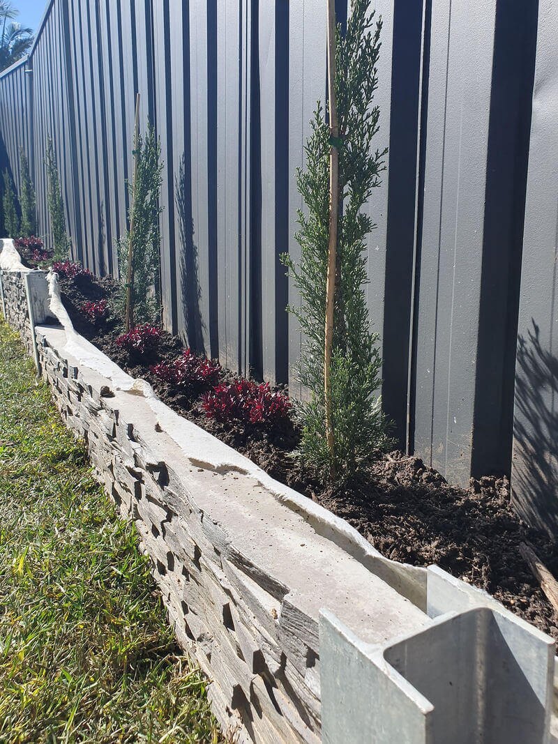 Raised garden bed built into a retaining wall
