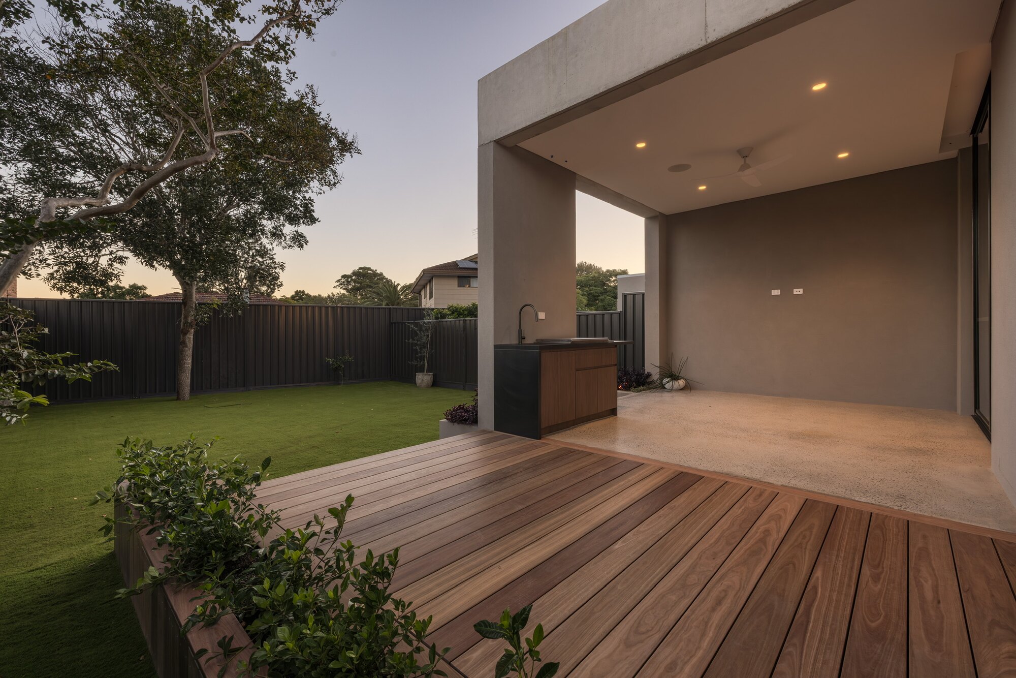 Timber deck connecting a modern home to the backyard lawn